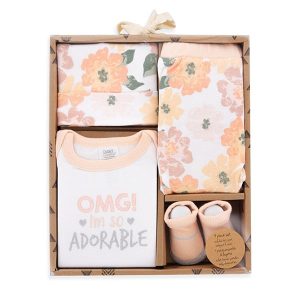 Boxed baby girl gift set containing white onesie with peach-colored flowers that says "OMG i'm so adorable" in peach and silver fonts with matching hat and pants of same design and pink socks.