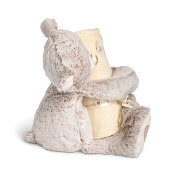 A light brown teddy bear with a light brown nose and light brown hearts on its paws holding a rolled soft light yellow blanket that says "loved".