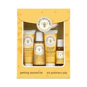 Yellow rectangular box with Burt's Bees logo an envelope style closure on top with clear front to see product containers inside.